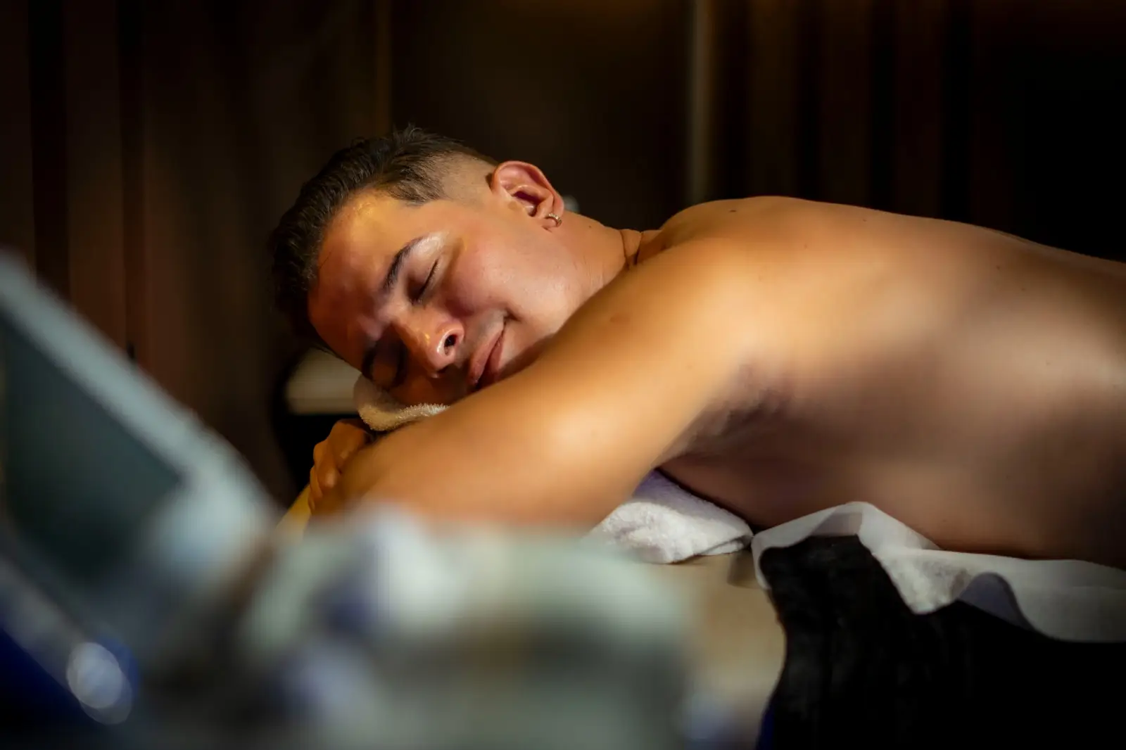 Client relaxing on the massage table at Black Spa, a spa for men in Medellín